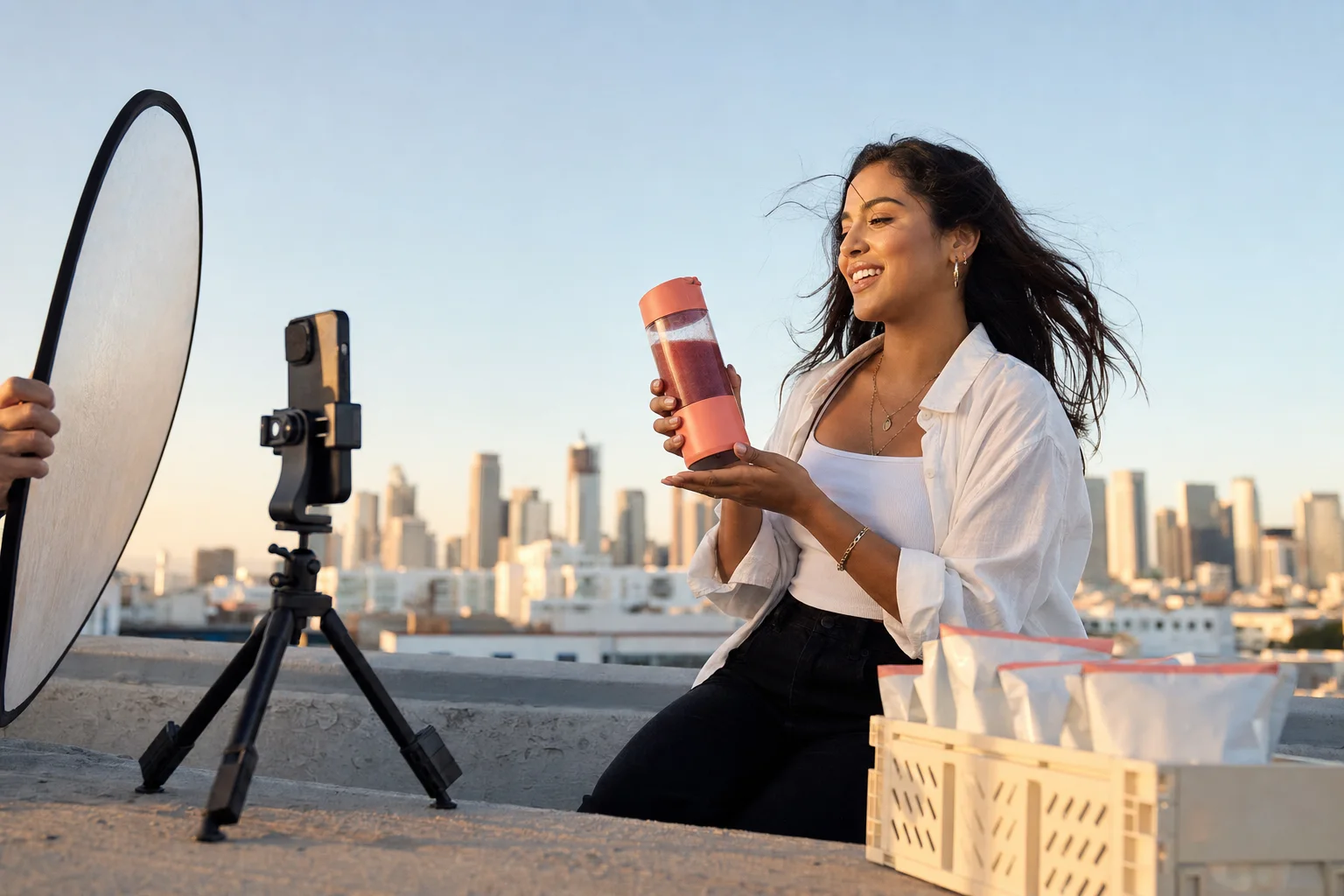A creator filming a polished product demo on a rooftop at golden hour